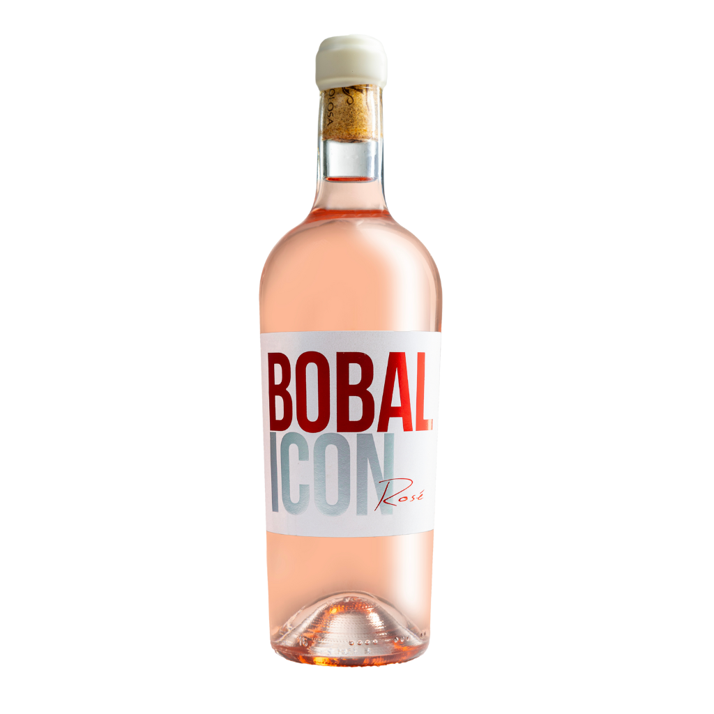 Botella de vino rosado Bobal Icon con etiqueta blanca y texto rojo, destacando un diseño moderno y elegante con tapón de corcho, ideal para ocasiones especiales y certificado de calidad.